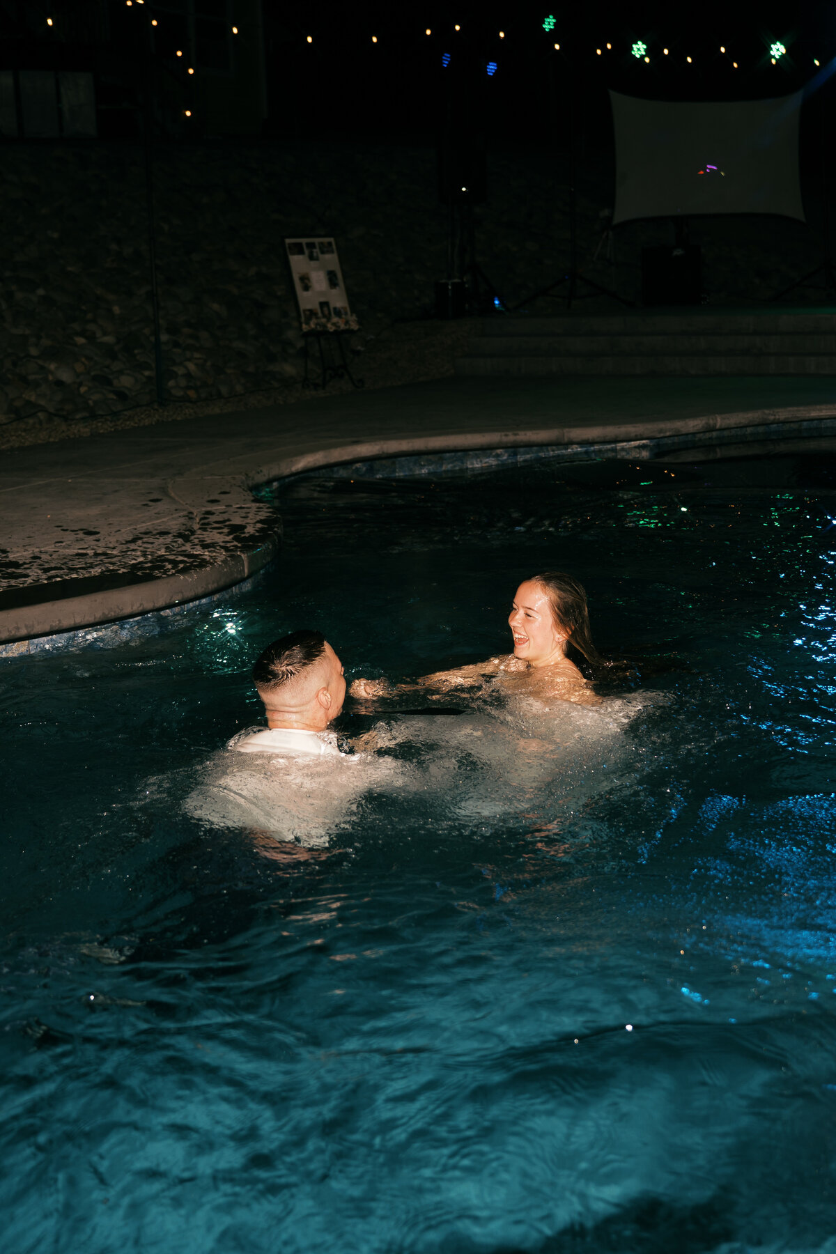 Engaged couple on horseback, girl is touching his face with her engagement ring hand
