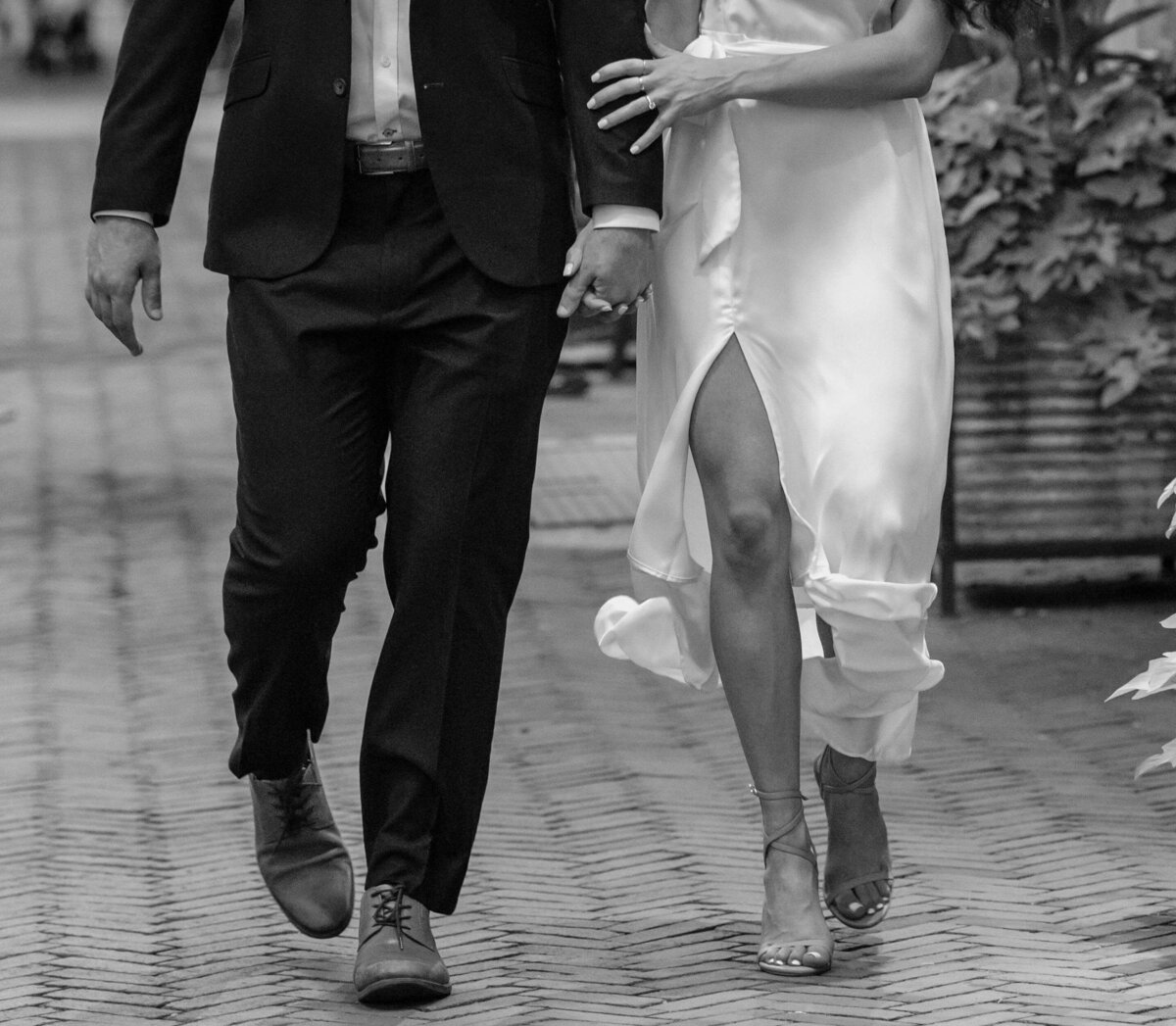 close up of formal engagement session photography holding arms and walking city streets in baltimore maryland