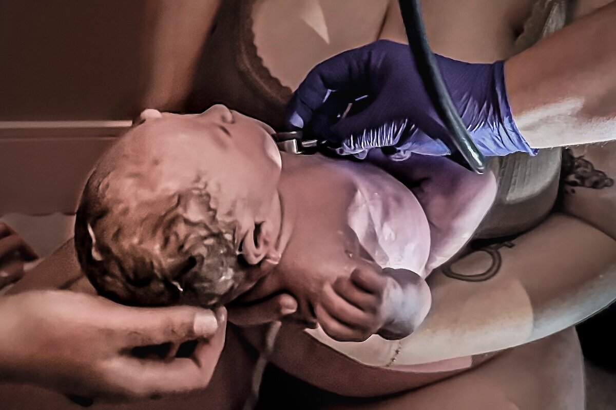 an Edmonton mom holding her baby after giving birth