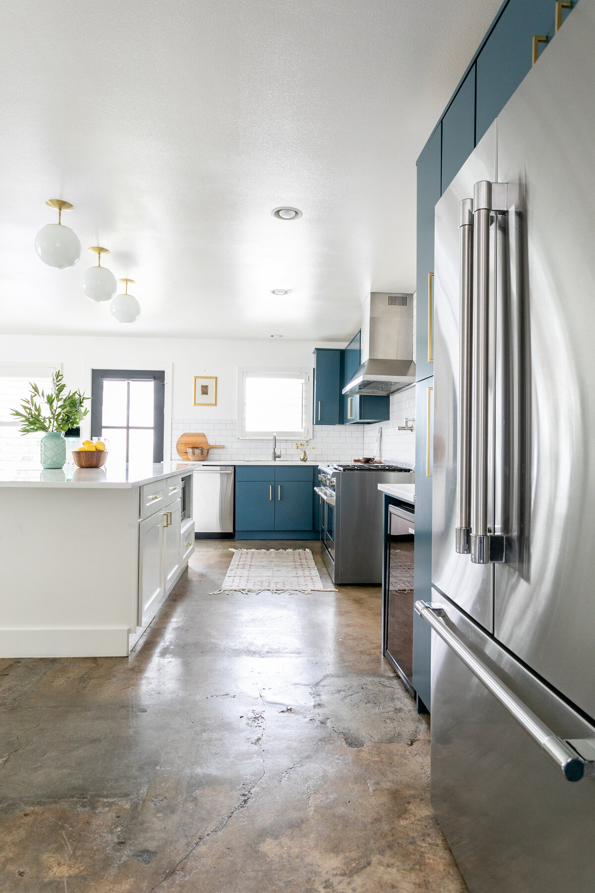 hello-home-austin-teal-kitchen-remodel-open-layout-semi-flush-pendants-l-shape-kitchen-stained-concrete-floors-10