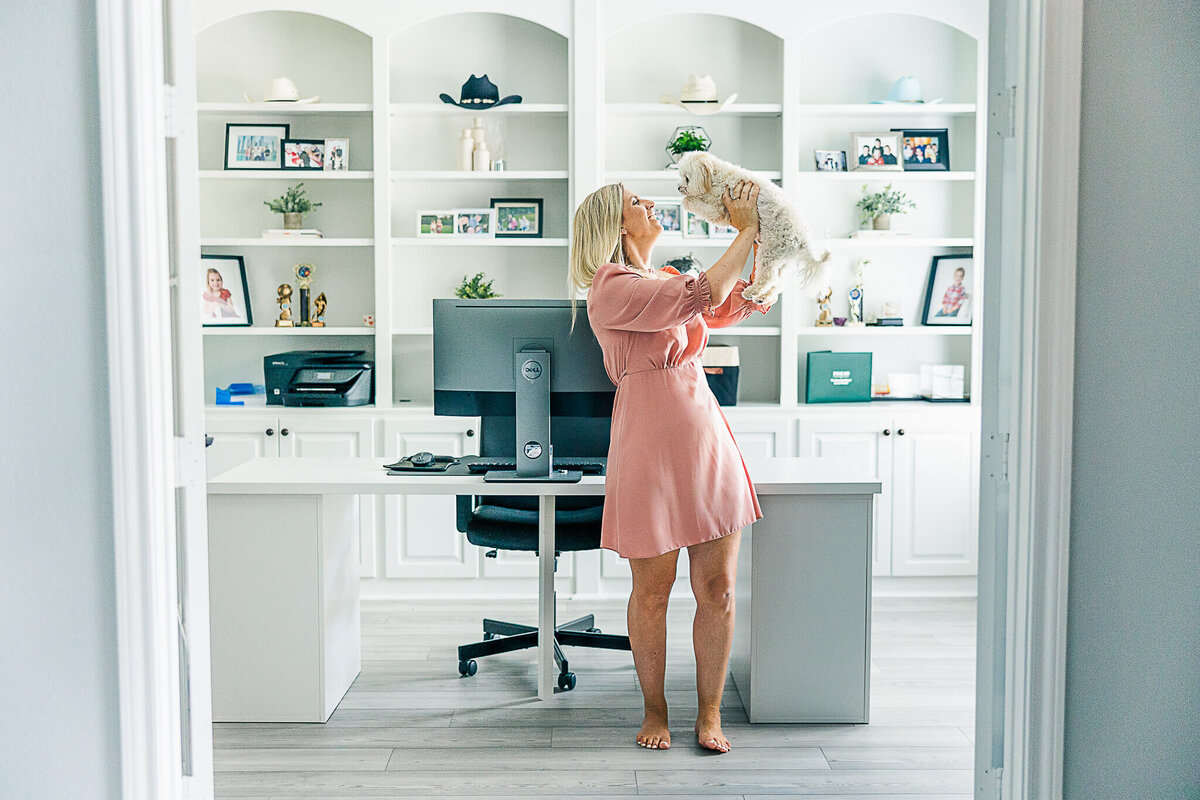 Claire holding dogs in white study