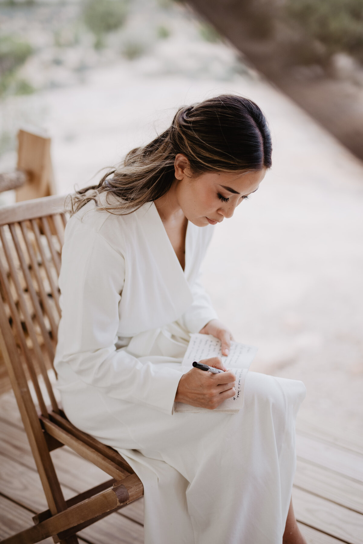 Utah Elopement Photographer captures bride wearing white robe during. vows