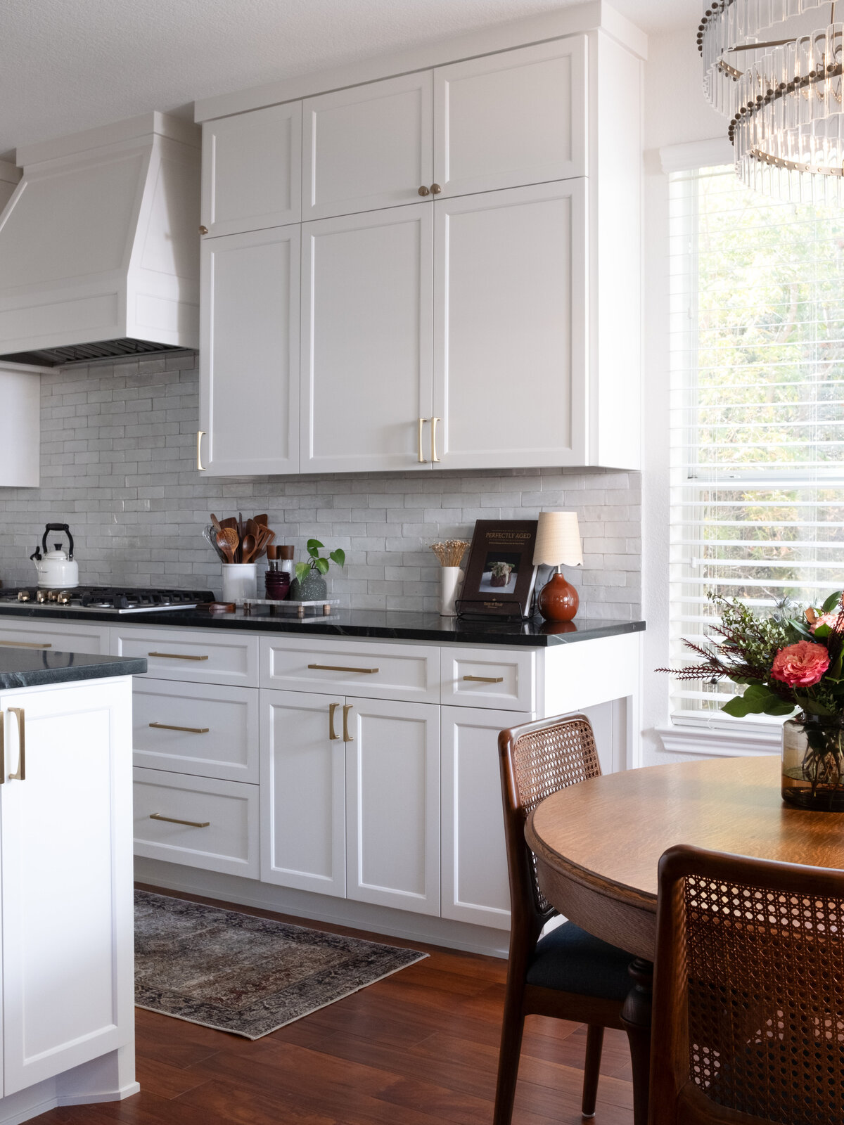 hello-home-austin-cream-kitchen-remodel-zellige-backsplash-contemporary-kitchen-vintage-breakfast-nook-tapered-vent-hood-soapstone-countertop-13