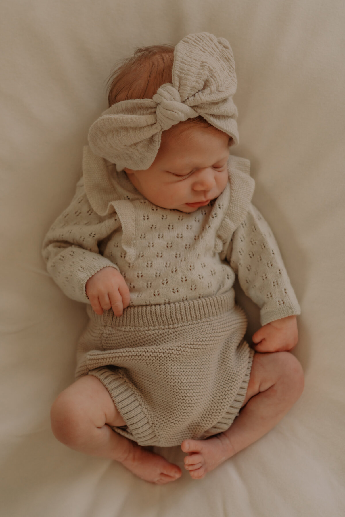 Newborn ligt heerlijk te slapen op een beanbag waar de foto's worden genomen van de baby tijdens de newbornshoot.