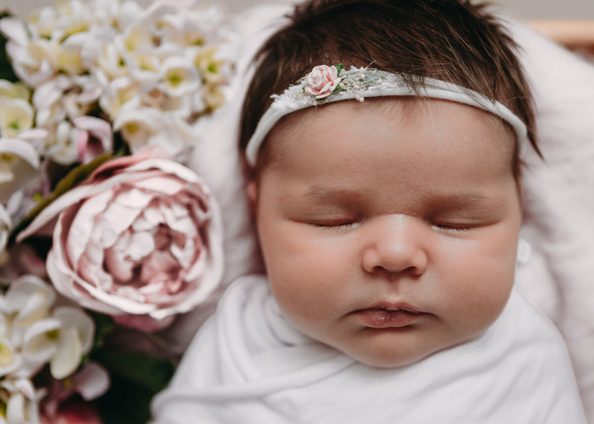 Baby wrapped and sleeping in a newborn photography session by Lauren Vanier Photography