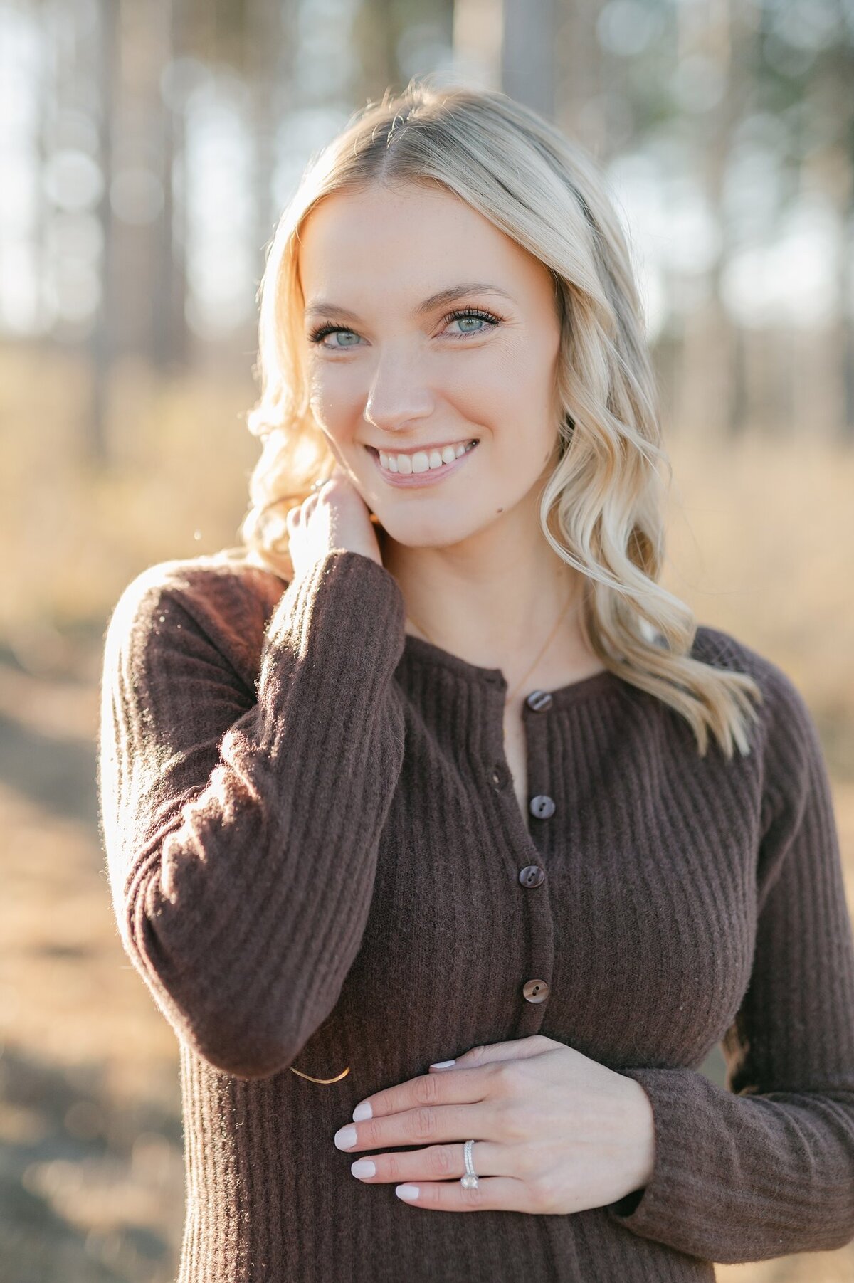 Pregnant woman smiling at the camera in Elm Grove, Wisconsin