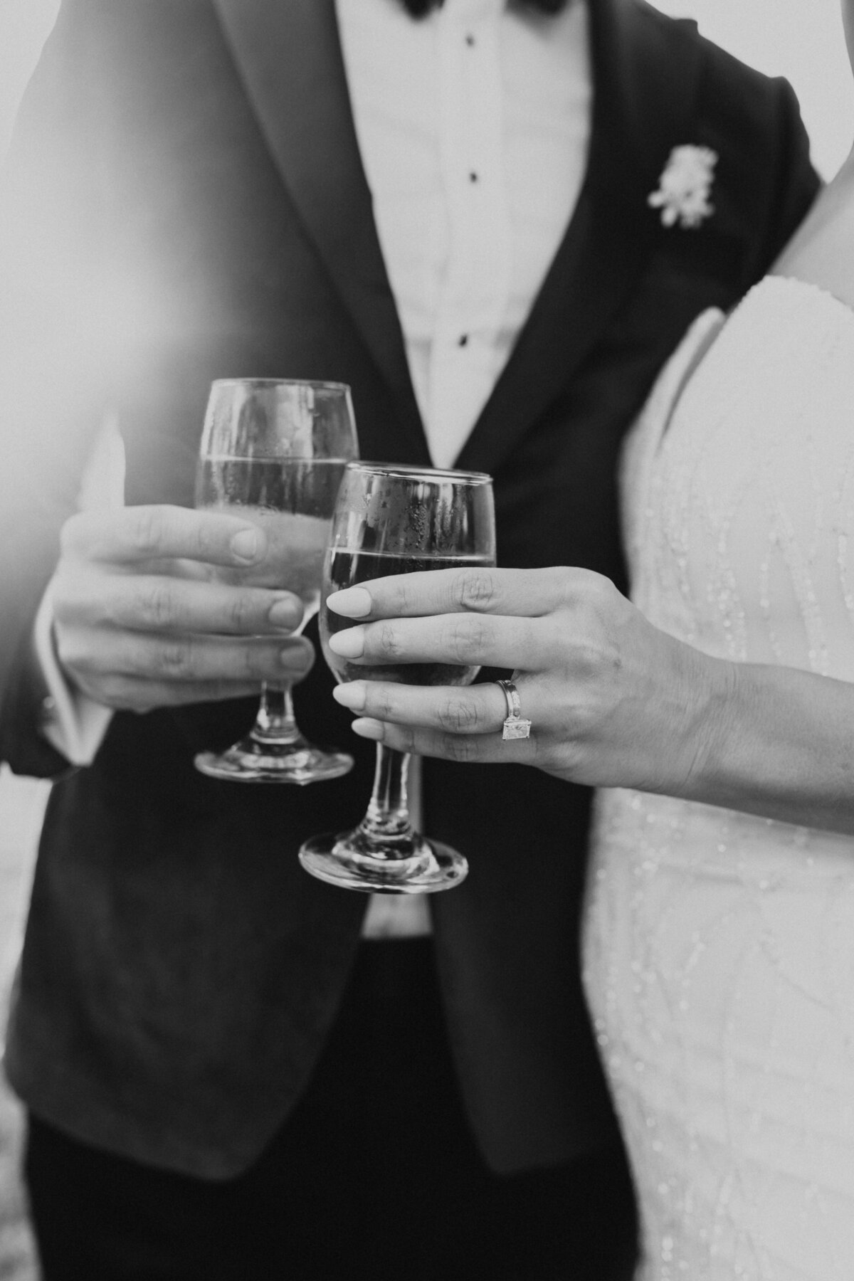 detail photo of couple holding champagne glasses