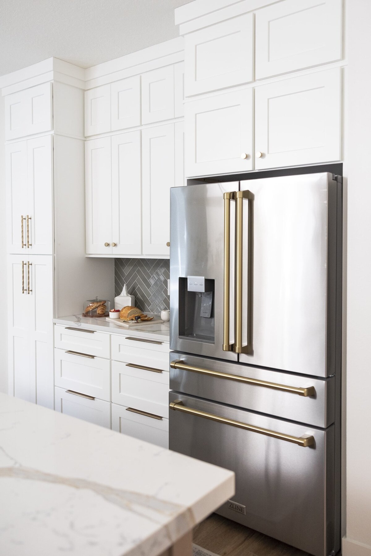 dewine design orlando interior designer belle isle kitchen with fridge with gold handles and white cabinets