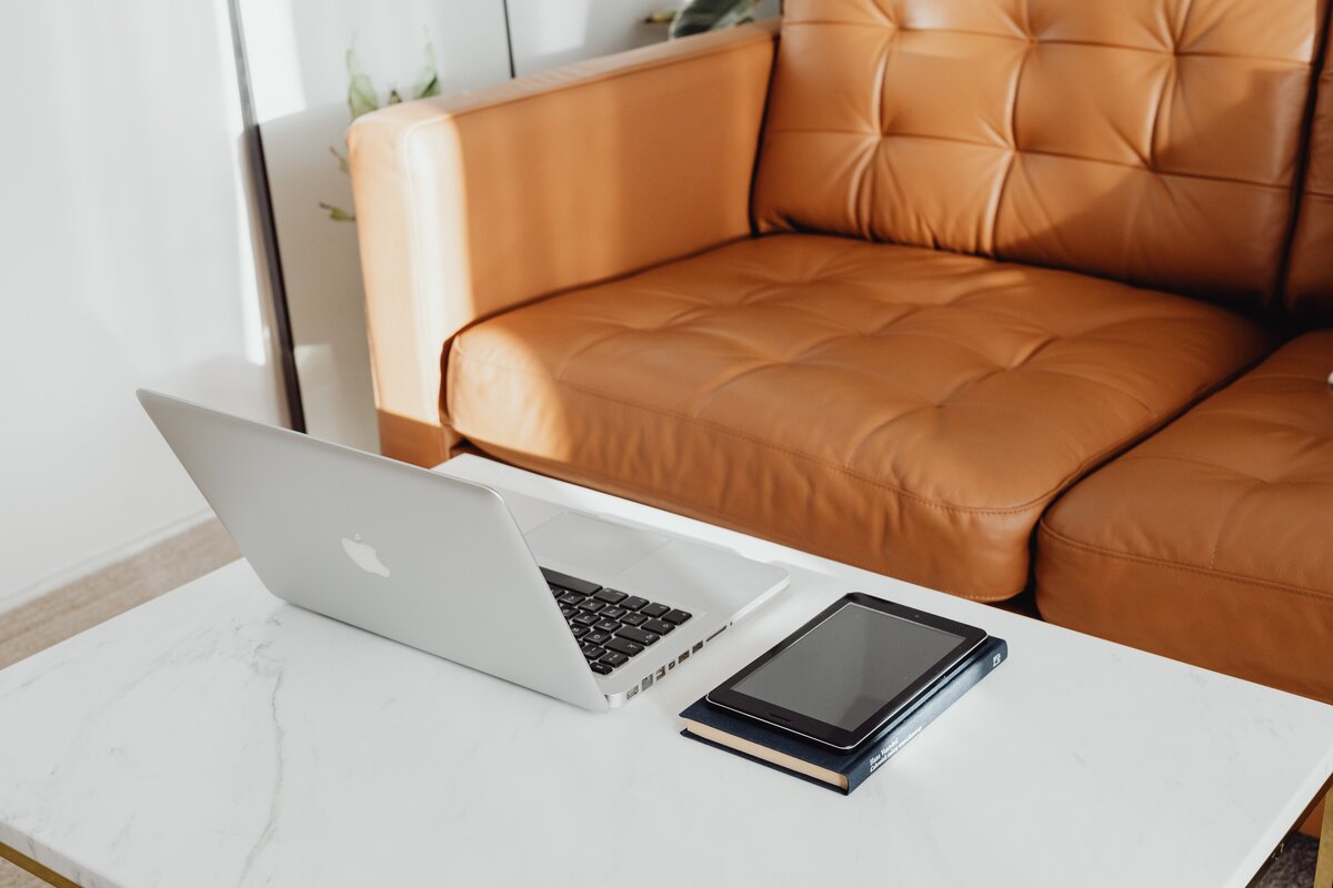 modern boho sofa interior design displayed with a macbook computer