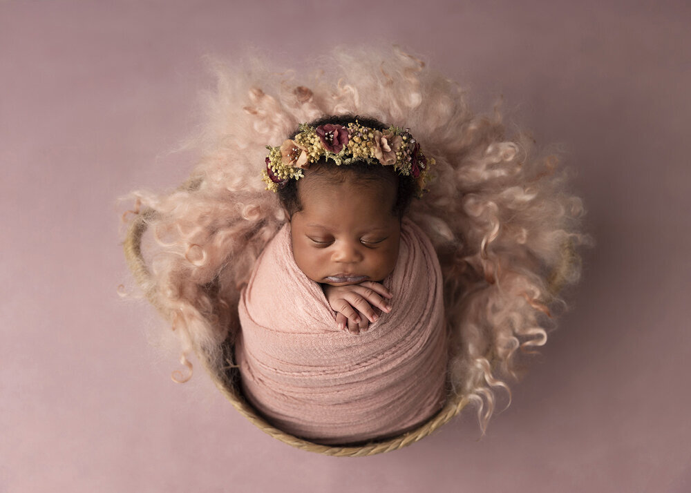 NEWBORN_BABYGIRLINWICKERBASKETWRAPPEDINPINK