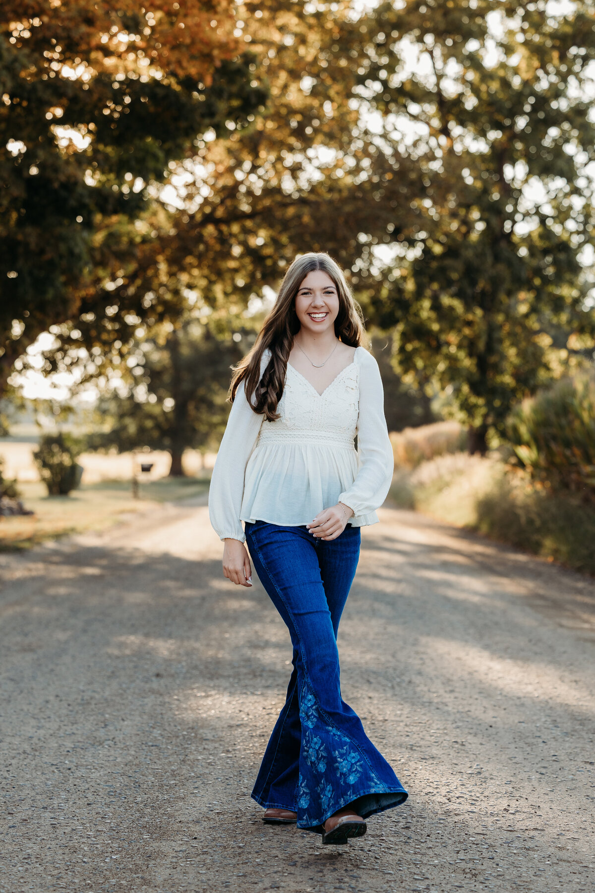 senior-girl-walking-down-dirt-road