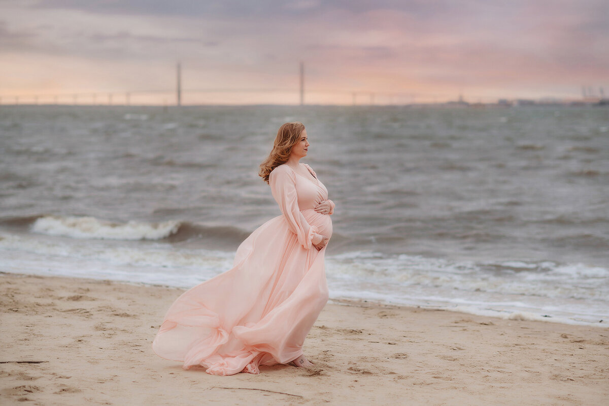 Pregnant woman poses for Maternity Portraits on the Beach in Charleston, South Carolina.