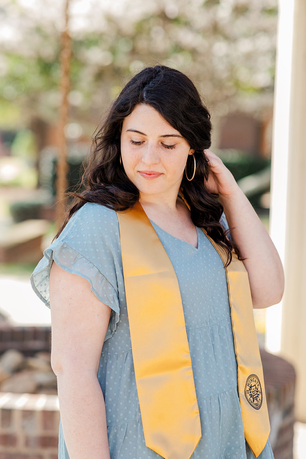 Joyful senior portraits with natural spring backdrop