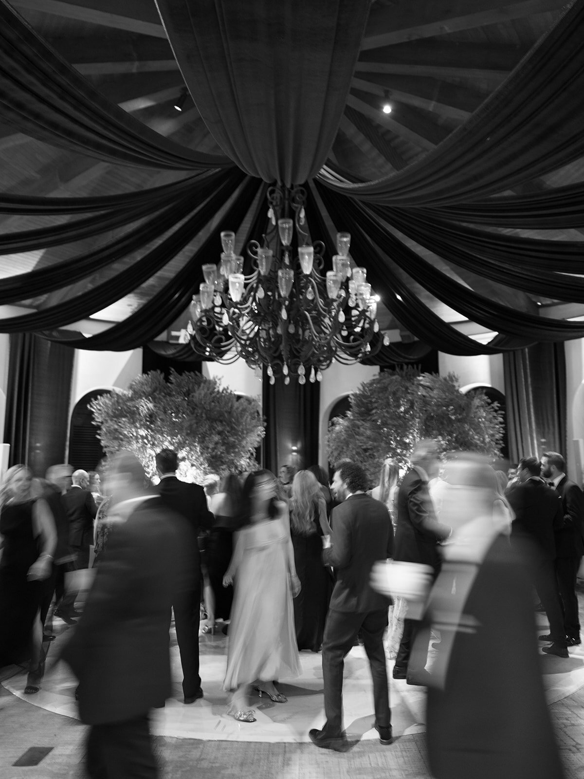 Wedding dance floor in the Ritz Carlton Bacara Rotunda with dramatic draping and olive trees