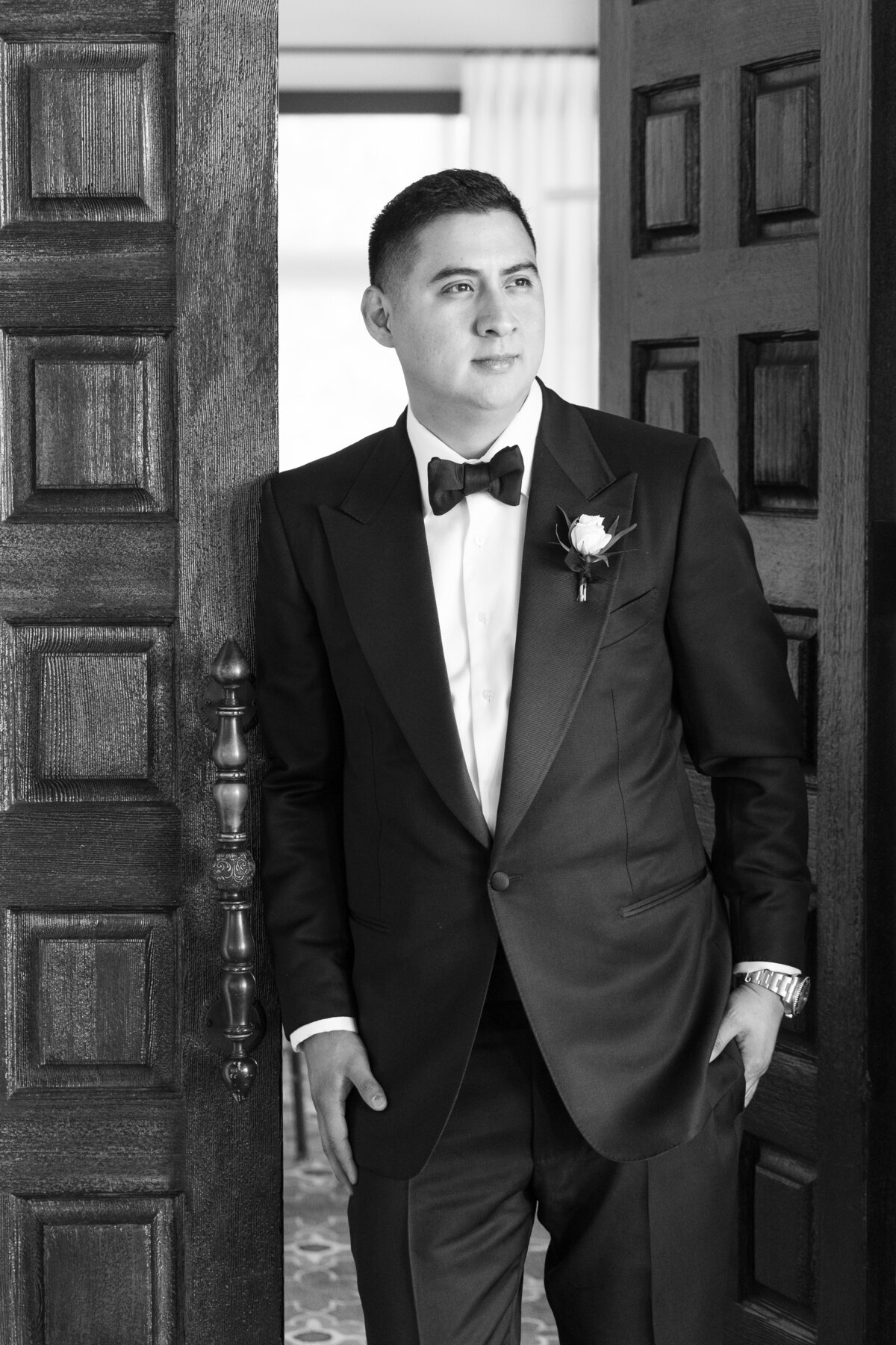 Black and white photo of a groom wearing a Tom Ford Tuxedo