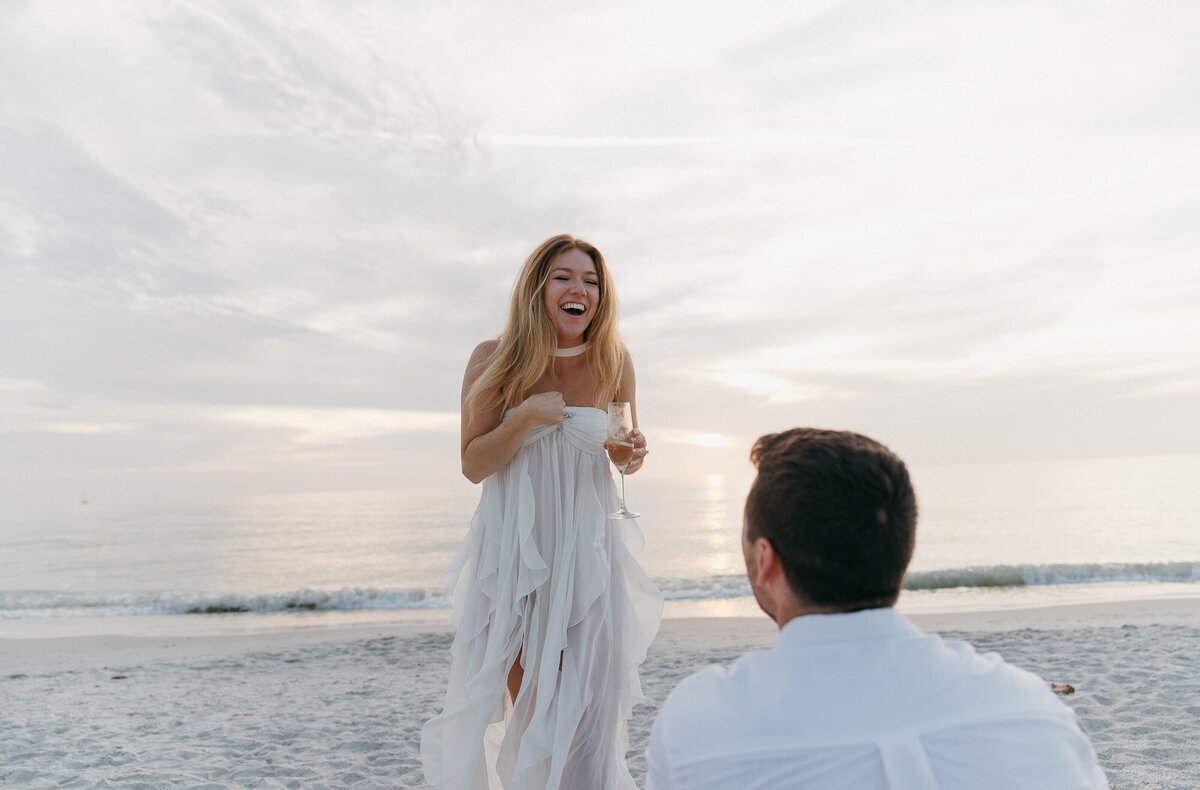 Groom with bride on beach taken by film wedding photographer