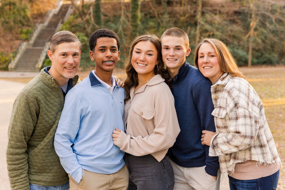 family with 3 teenagers in an Buckhead park standing on a park path  | Atlanta GA family Photographer | Laure Photography