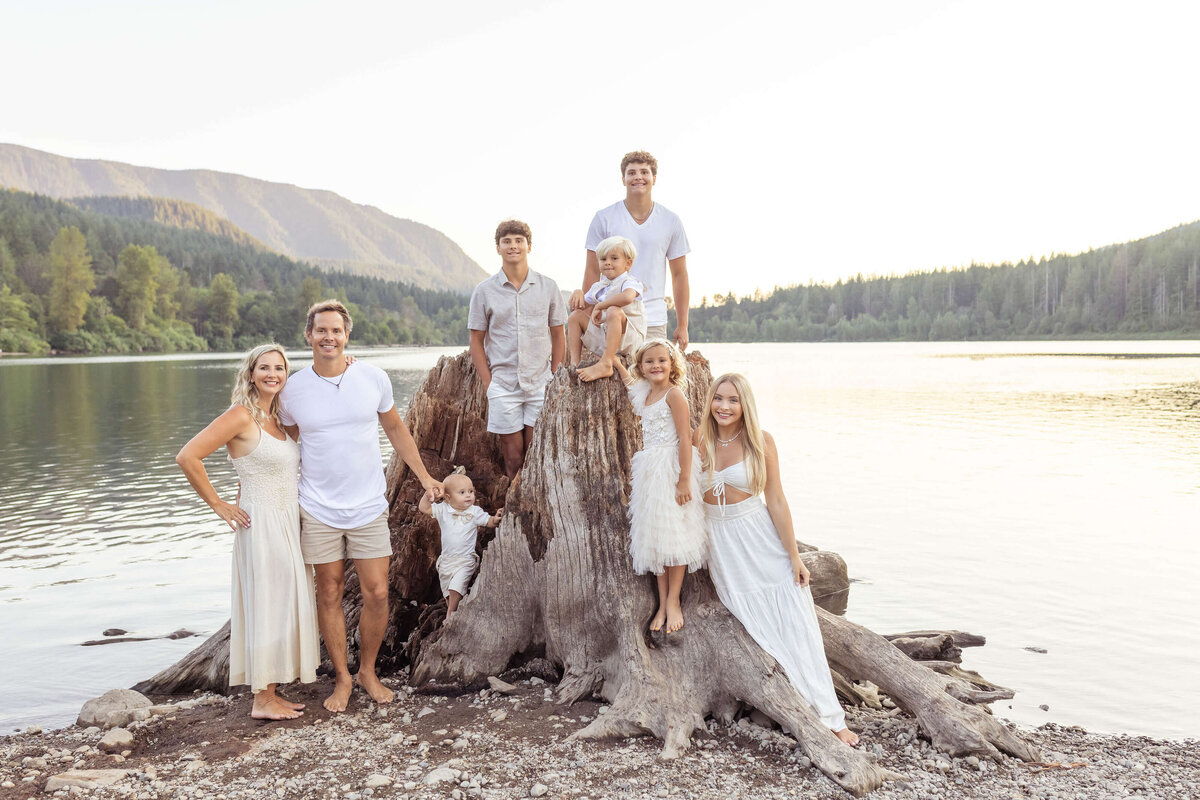 Large family standing near the lake in all white