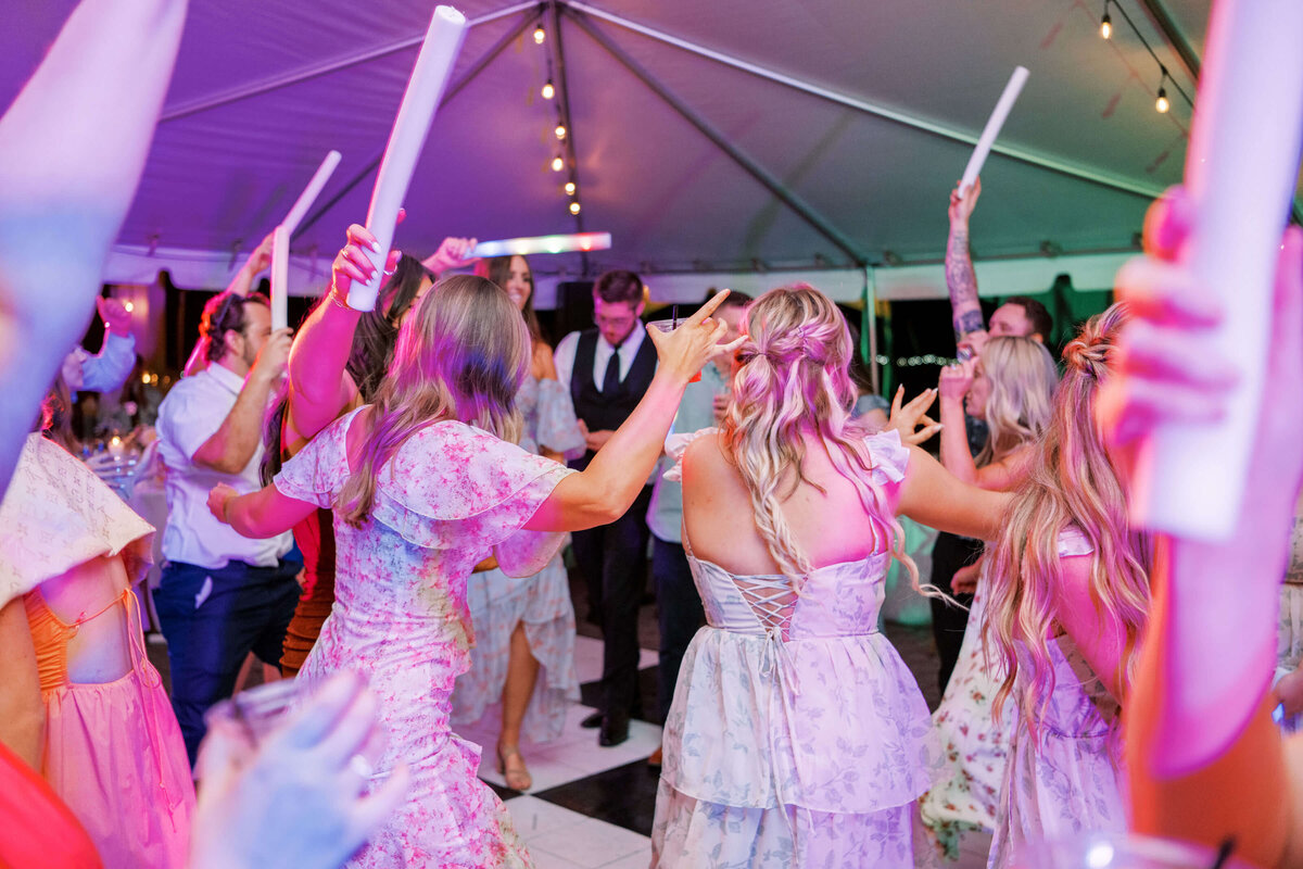 People dance and celebrate at an outdoor wedding planned by Birdie June Events.