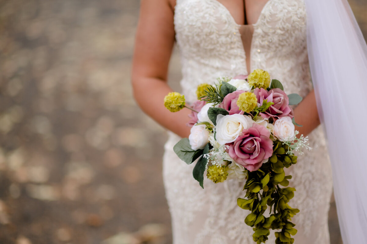 lace wedding dress and pink floral bouquet detail shot captured by Best Little Rock wedding photographer