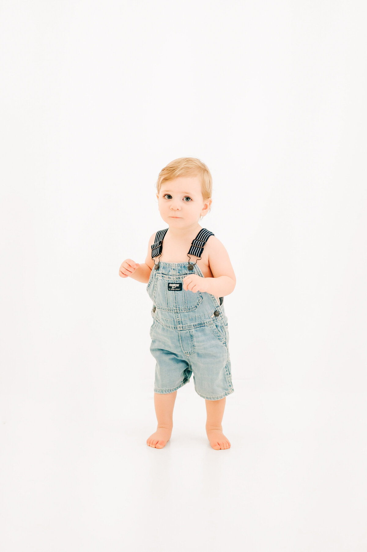 Springfield MO milestone and kids photography of boy in overall in photography studio