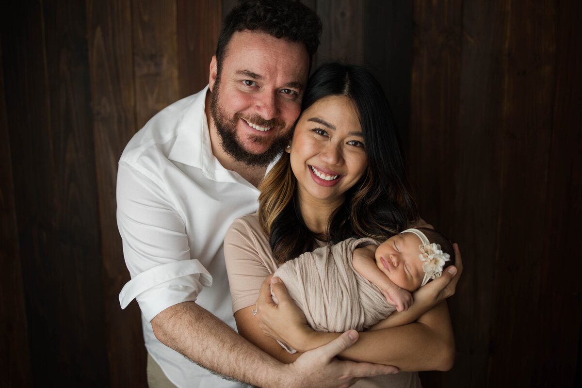 Newborn Baby Girl with Parents Smiling