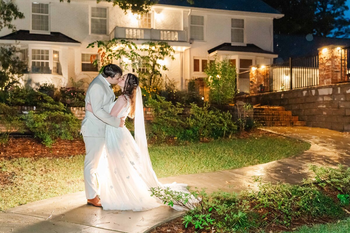 Bride and groom kiss in a romantic, rainy night photo in SC wedding
