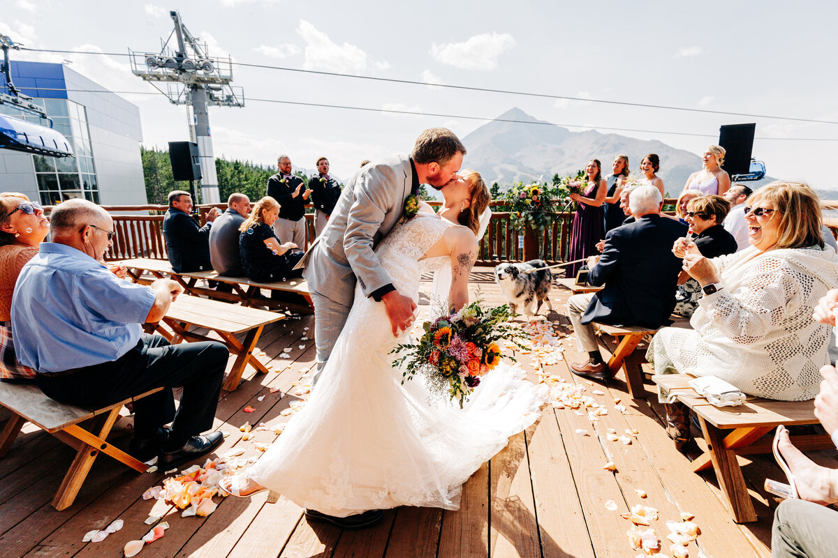 Bride and groom ceremony exit dip at Everett's 8800 in Big Sky, Montana