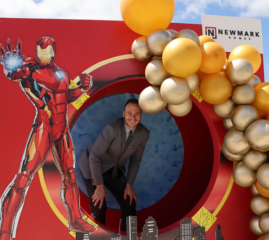 Newmark Homes corporate event Superhero themed photo booth backdrop design