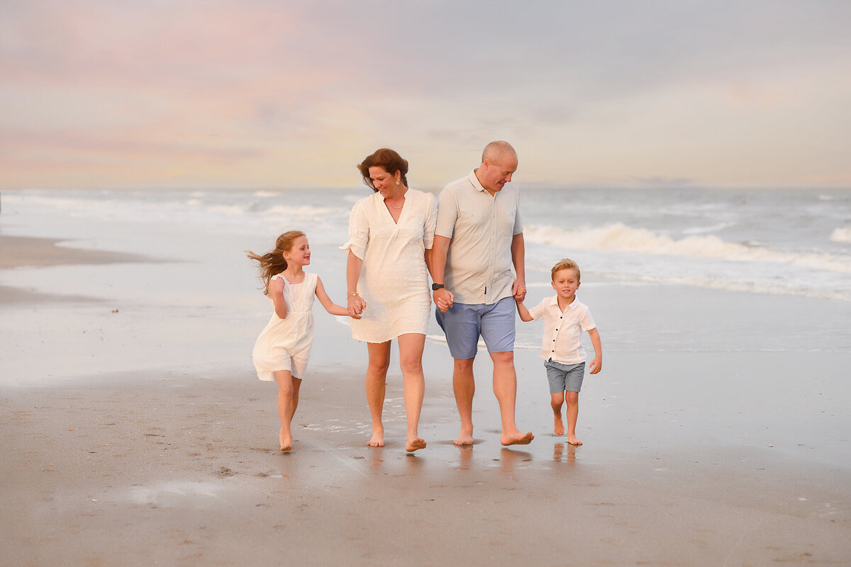 Family walks along Isle of Palms beach together during their Family Photoshoot on Isle of Palms.