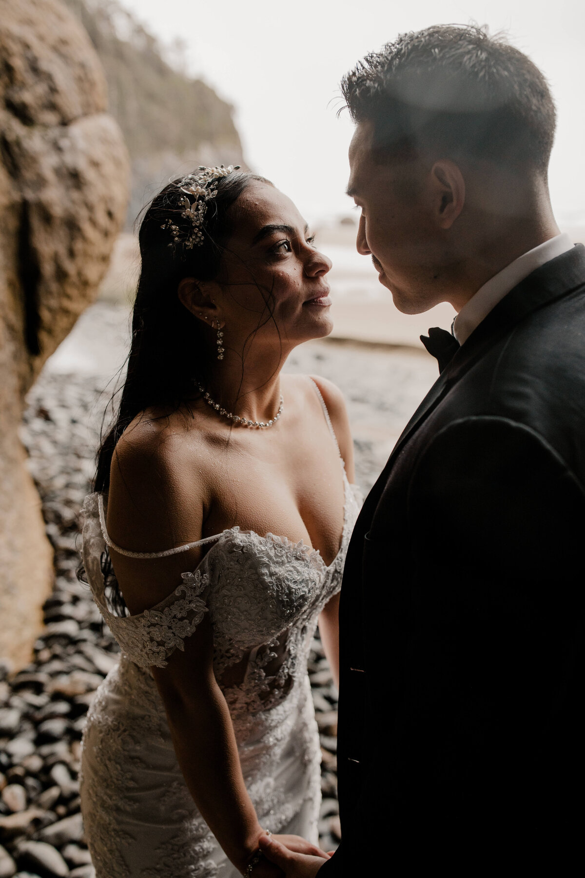 Couple poses under a cave at an oregon coast elopement
