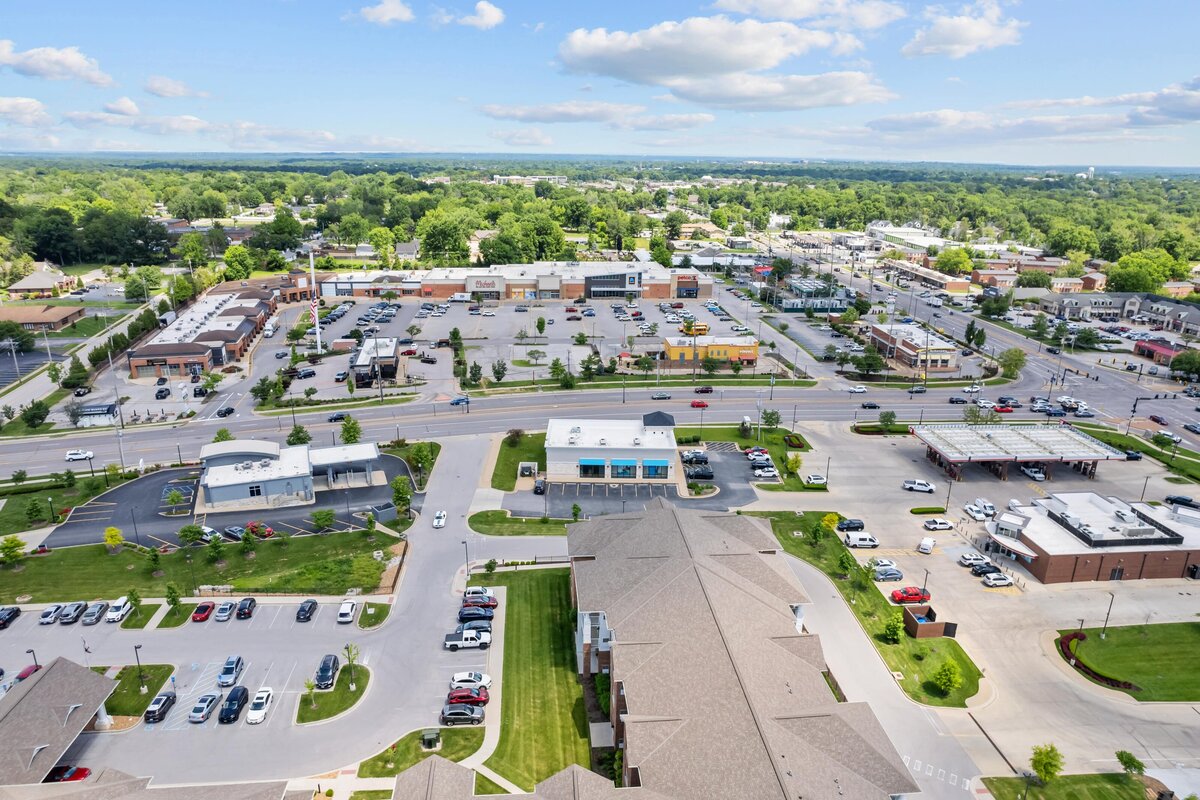 Aerial photograph of an A T and T building, showing a shopping center in the background.