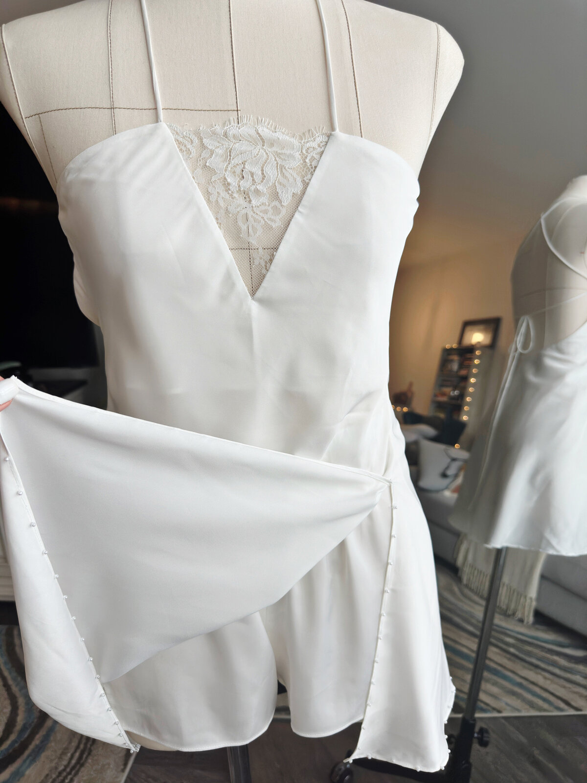 Buttery smooth ivory slip dress featuring delicate hand-beaded trim
