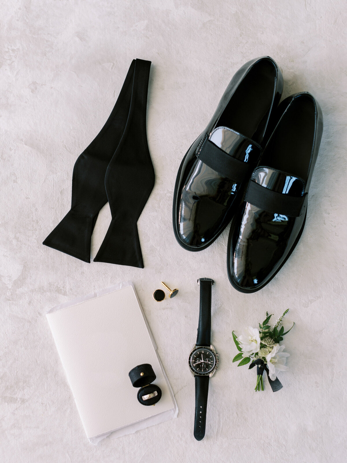 Flat lay of grooms details for Azure Romance wedding.