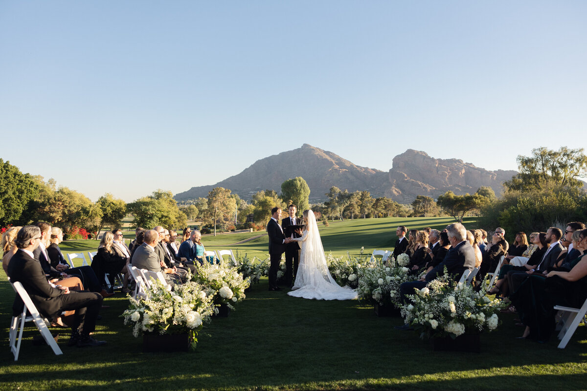 Bride and groom holding hands at wedding ceremony in Paradise Valley, Arizona