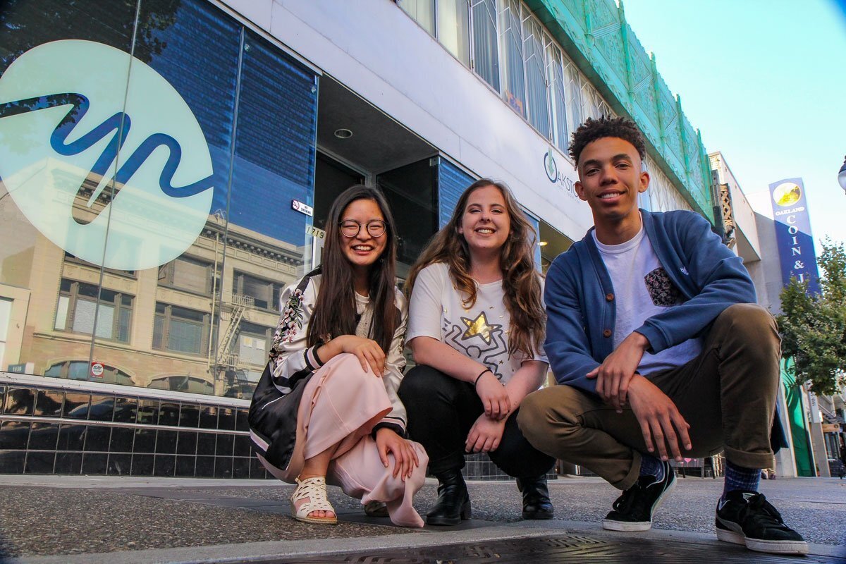 Group of teenagers smiling in front of the YR media building