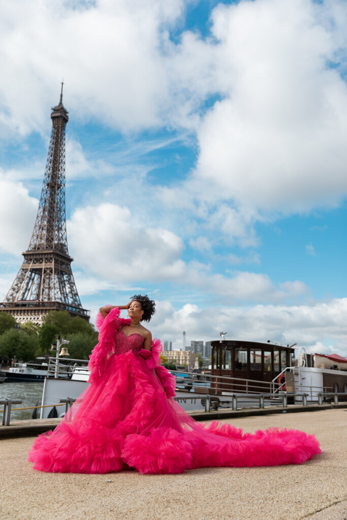 Glamorous Paris portrait by Seine river with woman in sparkling fuchsia princess gown and Eiffel Tower view