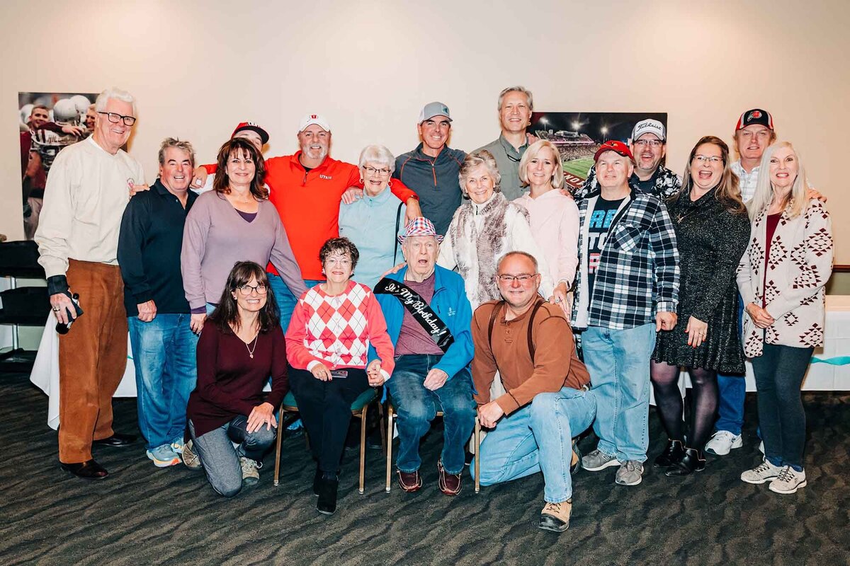 Man sitting with family at his 90th birthday party