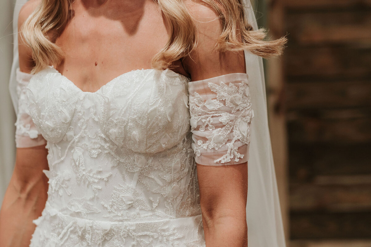 Close up details of a Bride's beautiful white lace wedding dress