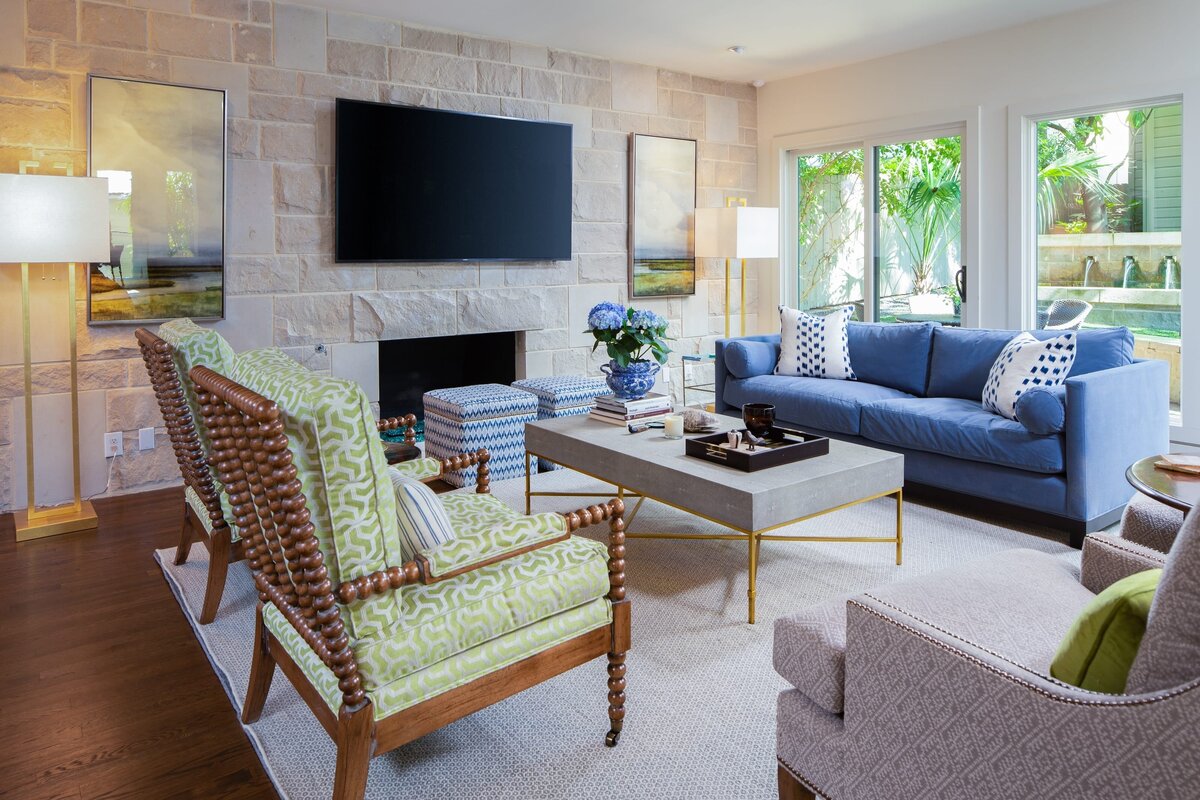 the keeping room interiors grant living room with blue sofa and blue flowers on table