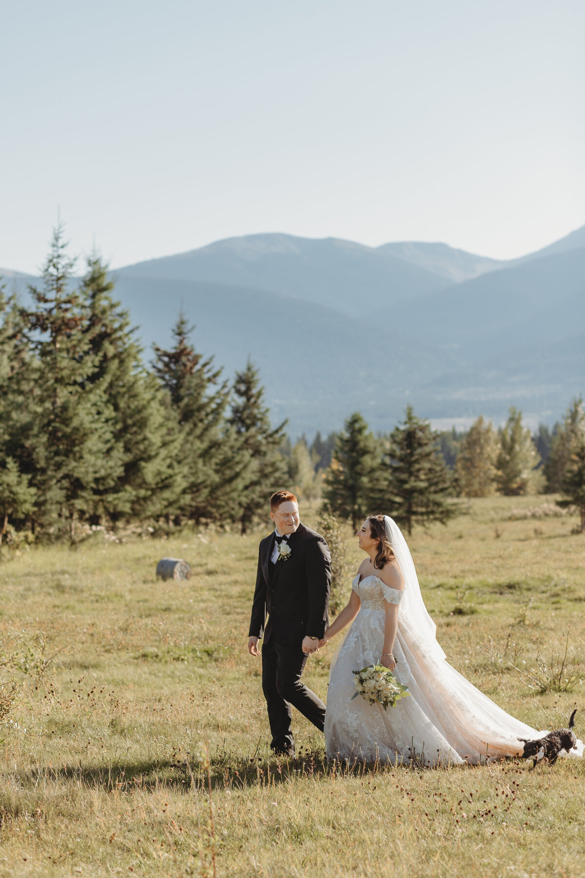 Alberta bride and groom walking in the mountians