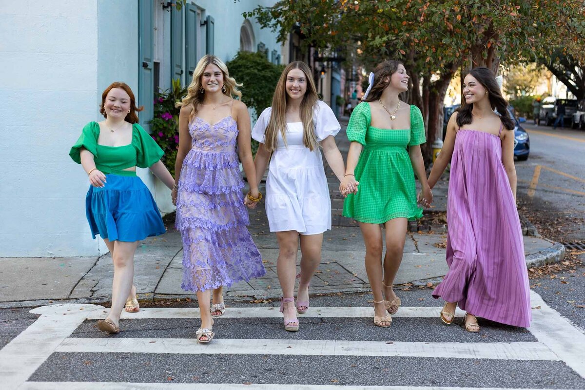 MBP Senior Team walking in a cross walking holding hands in Lawrence, KS