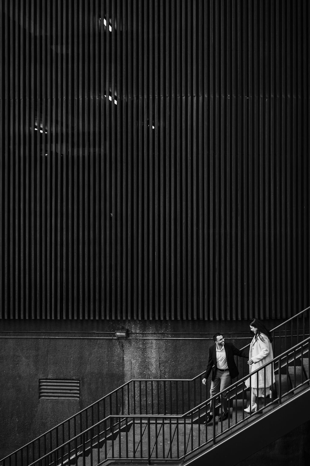 A couple walk down stairs in Chicago, IL