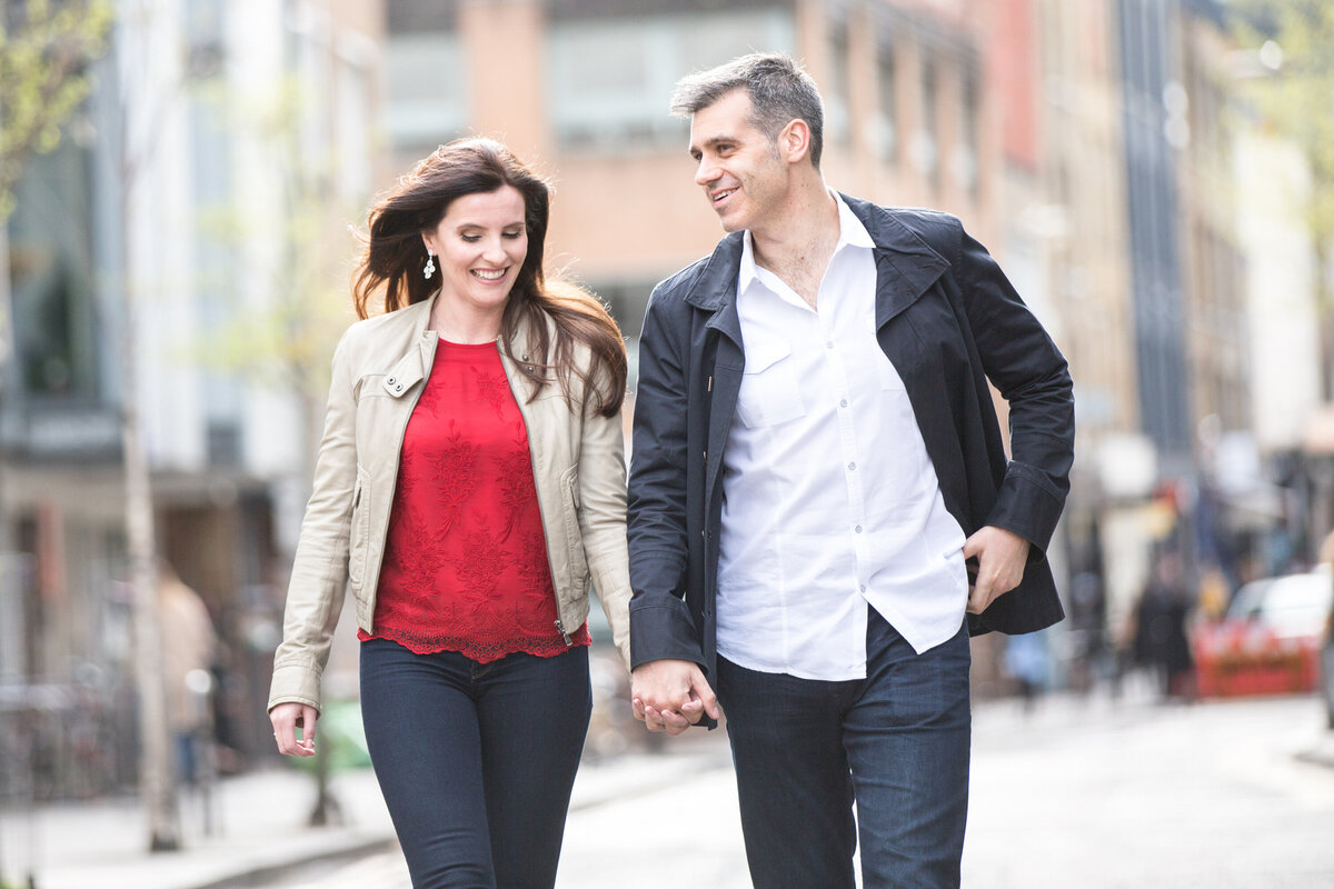 woman in red walking with man in black jacket