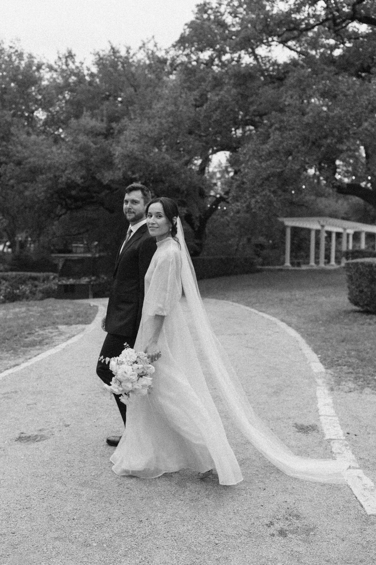 Bride and groom walking in the grounds of Laguna Gloria in Austin