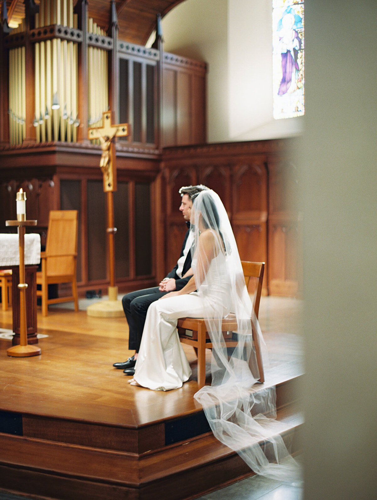 bride and groom site during ceremony at Dahlgren Chapel