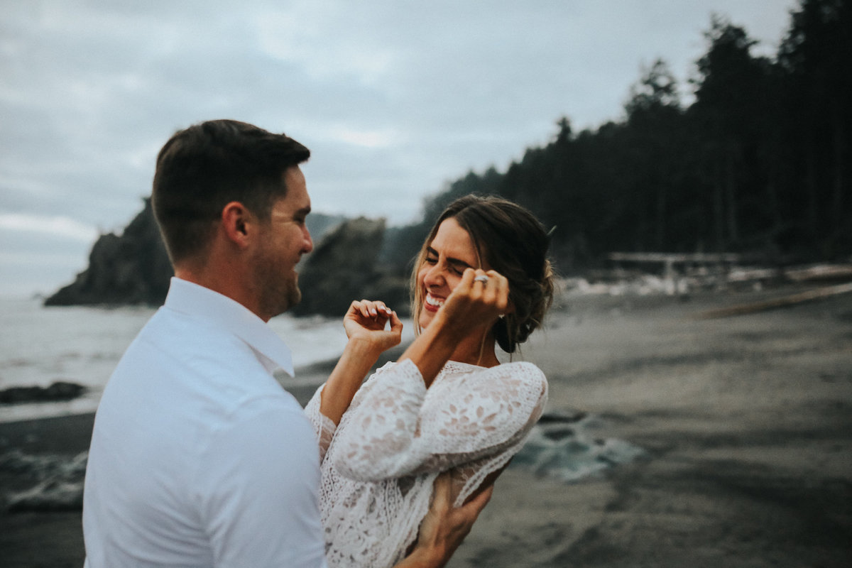Bride and groom have fun with eachother after their elopement ceremony at Rialto  Beach in Olympic National Park.