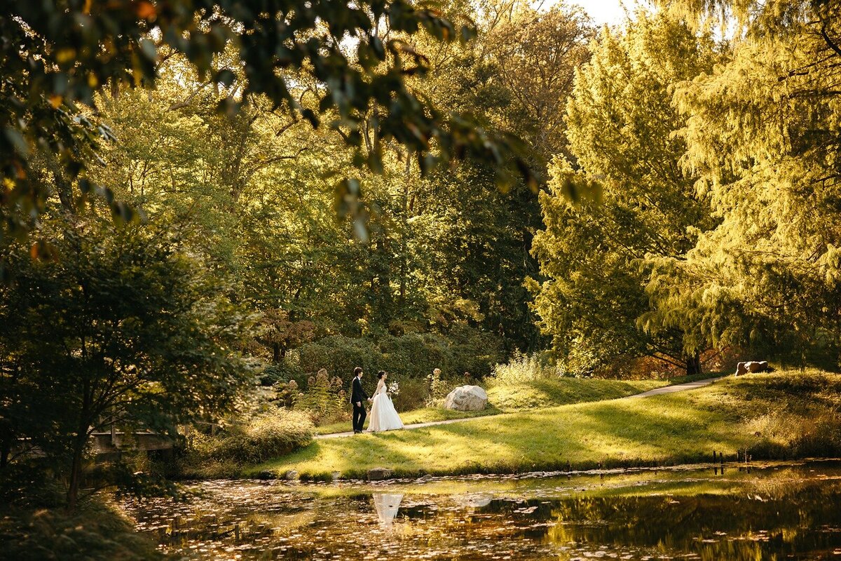 Bride and groom walking in open space field