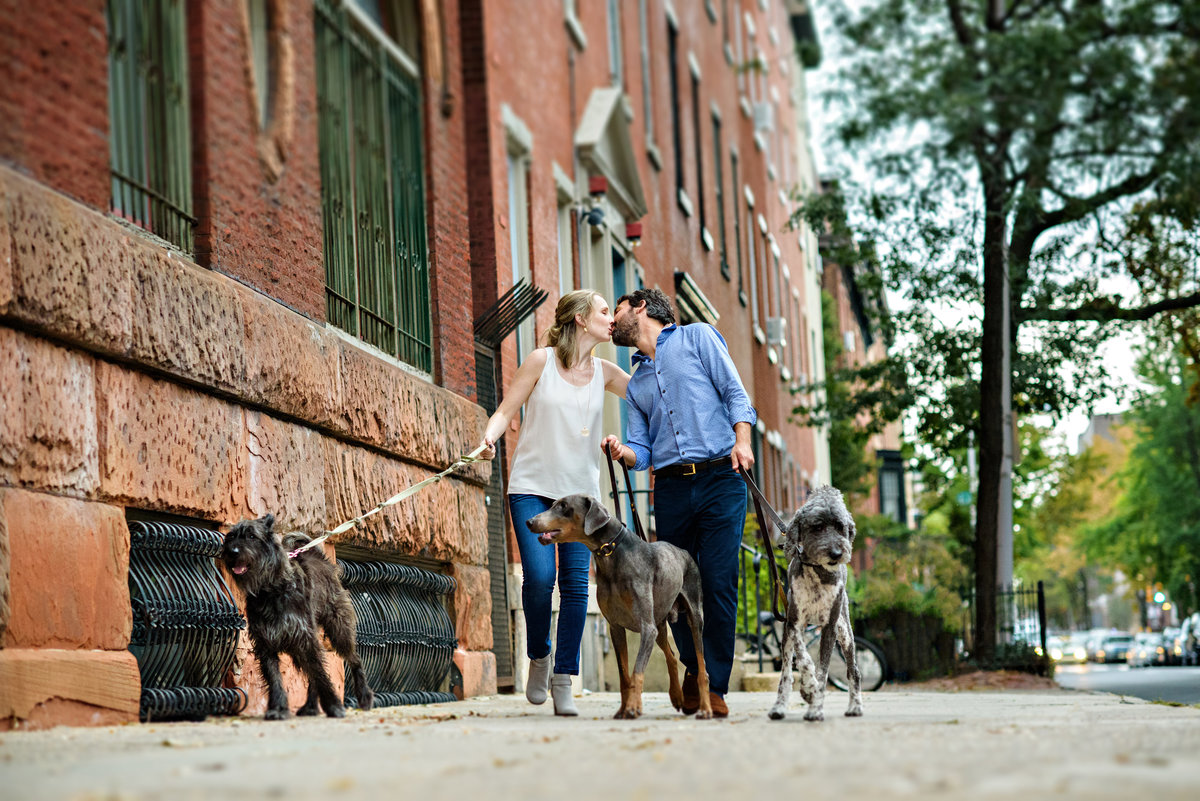 A fun philly couple walk their dogs.