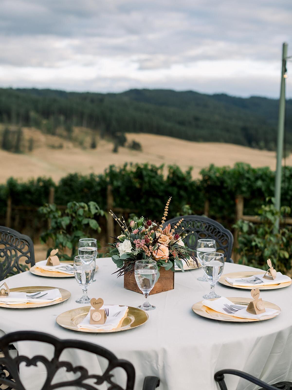 Wedding reception table with beautiful centerpiece floral arrangement.